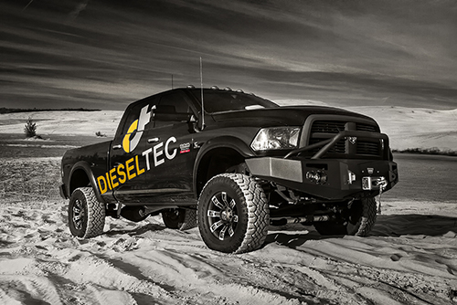 black diesel truck with the Dieseltec decal on the door shown parked on dunes